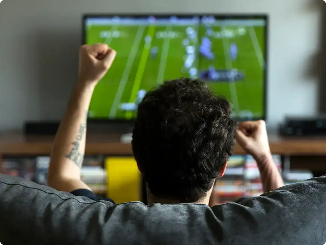 Man watching sports on TV.