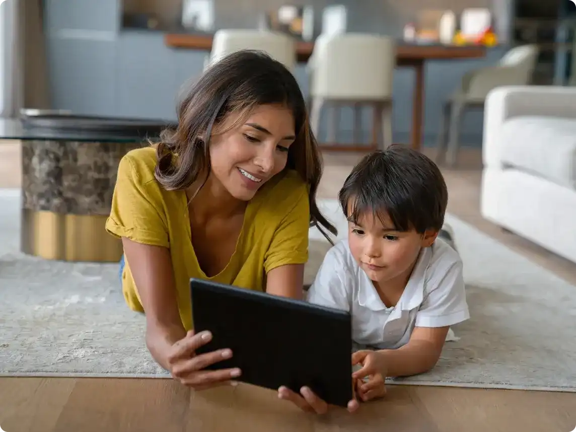 Mother and child play with tablet.
